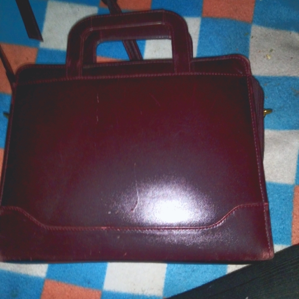 A burgandy genuine leather organizer purse
